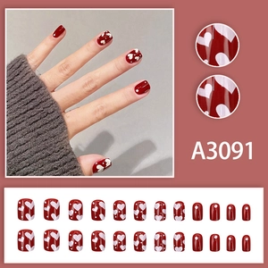 Short cherry red press-on nails with white heart patterns and dots, 24 piece nail set