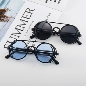 Cyberpunk round sunglasses with black and blue lenses on a summer fashion magazine