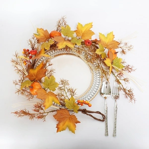 Detail of 100cm autumn maple leaf and pumpkin garland surrounding a white dinner plate