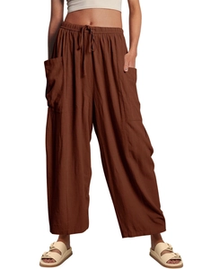 Detail of brown wide-leg trousers showing drawstring waist and large side pocket texture