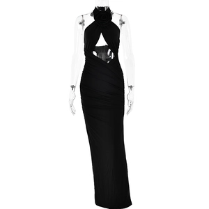 Detail of elegant black halter dress featuring a 3D floral accent and waist cut-out design