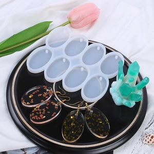 Detail view of 8-hole oval silicone mold for DIY resin earrings and finished jewelry pieces