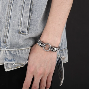 Detail of a vintage silver skull bracelet with braided stainless steel links for men