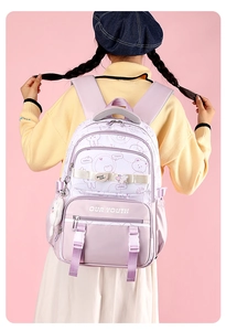 Detail of lavender backpack with cute cartoon illustrations and plush bunny charm