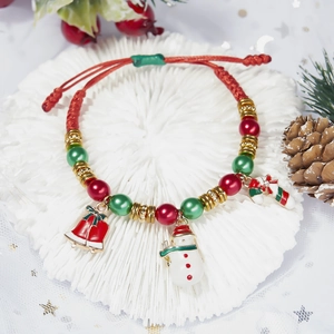 Close-up of adjustable woven Christmas bracelet with snowman and stocking charms