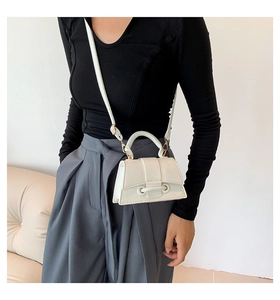 Close-up of white lychee leather mini square bag with golden buckle and handle detail