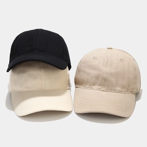 Close-up of three cotton baseball caps in black and beige with breathable eyelets