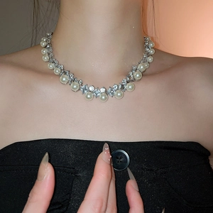 Close-up of elegant pearl and diamond-set necklace on neck for a sophisticated look