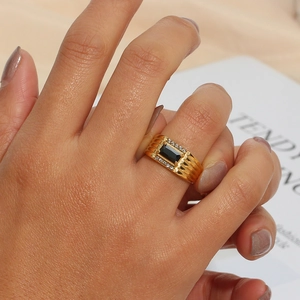 Close-up of 18K gold-plated ring featuring a rectangular black stone and zircon accents