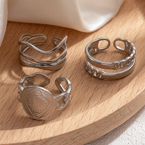 Three-piece set of silver stainless steel rings with irregular relief and wavy geometric patterns