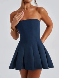 Side view of a dark blue strapless pleated mini dress with a waist-cinching fit