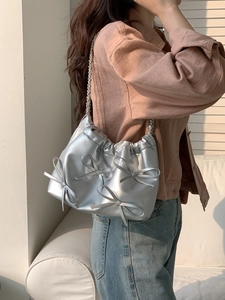 Silver PU leather shoulder bag with chic bow accents and a sleek metal chain strap