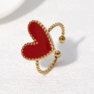 Adjustable twisted gold ring featuring a vibrant red enamel heart charm for women