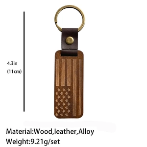 Detail of vintage wooden American flag keychain with brown leather and bronze rivet