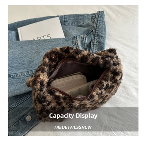 Detailed internal view showing large capacity for phone and wallet in leopard plush bag