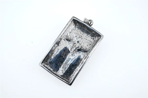 Detailed view of the square punk pendant with dark gothic skull eye and tree bark texture