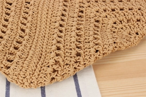 Macro shot of handcrafted hollow triangle pattern on natural woven shoulder bag texture