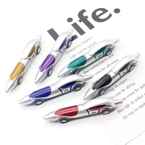 Close-up of six colorful car-shaped ballpoint pens on a minimalist white desk
