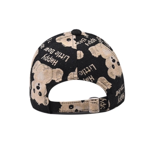 Detail of adjustable metal buckle and woven bear patterns on black canvas baseball cap