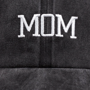 Detailed close-up of white MOM embroidery on vintage washed cotton baseball cap