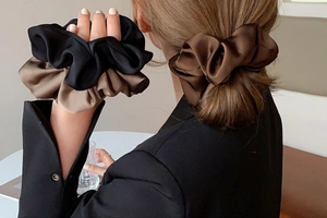 Close-up of premium satin scrunchies in earth tones featuring soft silk texture and high elasticity
