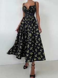 Detail of yellow lemon print on black summer dress with ruffled neckline and lace-up front