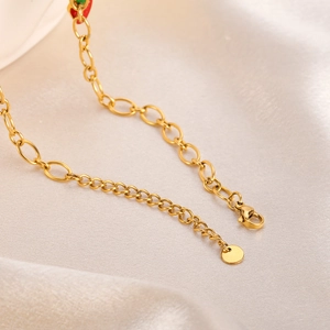 Close-up of gold lobster clasp and extension chain on stainless steel necklace