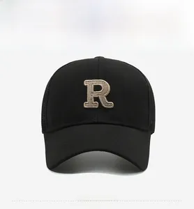 Detailed front view of black mesh trucker hat with 3D embroidered letter R and curved brim