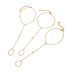 Three-piece gold plated anklet set with cross charm and zircon beads on white background