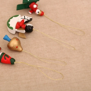 Detail of hand-painted wooden Christmas ornaments with angel and Santa motifs