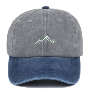 Detail of mountain embroidery on a gray and blue washed cotton baseball cap