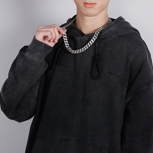 Hip hop silver cuban link chain with rhinestones worn by a model in a black hoodie
