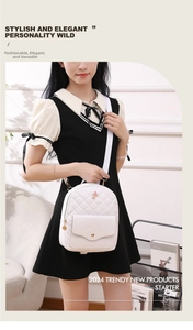 Close-up of white quilted backpack featuring rose embroidery and adjustable fabric strap