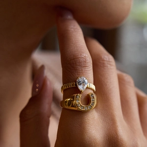 Luxurious gold-plated titanium rings set featuring a teardrop zircon and horseshoe band