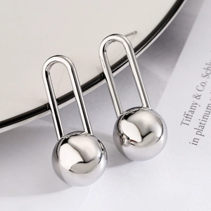 Minimalist silver spherical earrings in U-shaped geometric design with polished metal finish