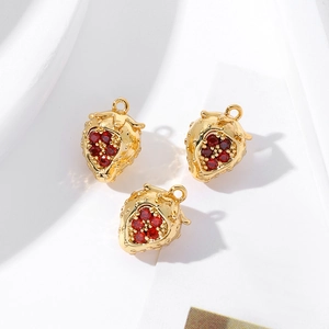 Detailed view of three 18K gold-plated strawberry charms with red zircon stones
