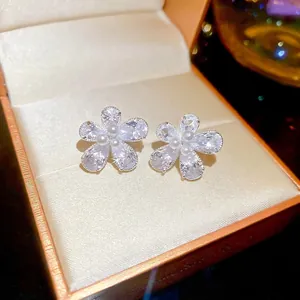 Silver flower stud earrings featuring water drop zircon petals and center micro pearls