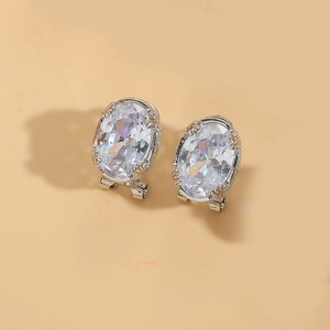 Close-up of sparkling oval crystal earrings with silver-toned four-prong setting