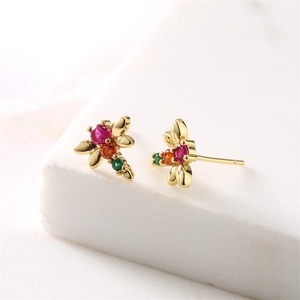 Macro view of gold dragonfly earrings featuring vibrant colorful cubic zirconia gems