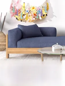 Detail of macrame toy hammock with colorful tassels holding stuffed animals on wall
