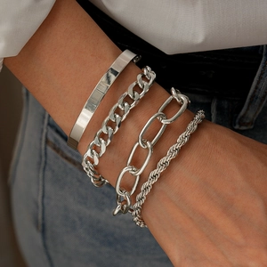 Detailed close-up of a 4-piece silver geometric chain bracelet set with polished finish