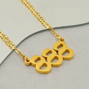 Close-up of golden number 888 pendant on a fine link chain with polished metallic finish