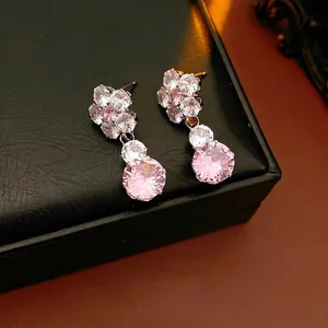 Luxury gold-plated flower earrings with pink cubic zirconia on black leather jewelry box