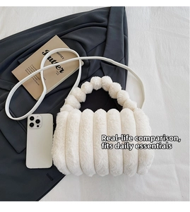 White faux fur tote bag showing interior capacity with a smartphone and books