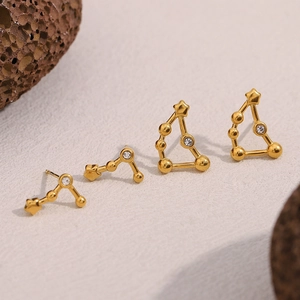 Detailed view of four 18K gold-plated stainless steel zodiac constellation stud earrings