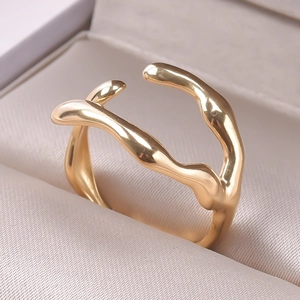 Macro view of gold irregular wave ring with liquid metal texture in a jewelry box
