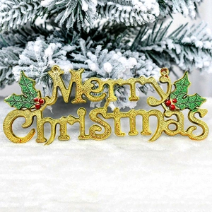 Detail of golden Merry Christmas sign with red berries and green leaves on snowy pine