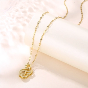 Golden swan pendant necklace with small rhinestones on a stainless steel chain