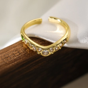 Macro shot of 18K gold plated ring featuring wave design with clear zircon stones