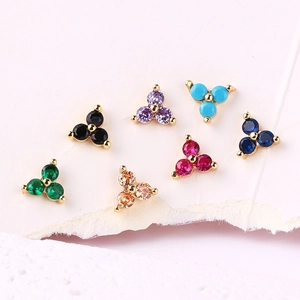 Macro shot of colorful zircon stud earrings in seven vibrant gemstone color options